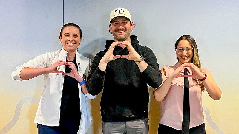 three people holding their hands in the shape of Os