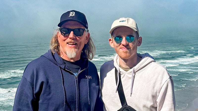 Kurt and McKain Williams pose with the Oregon coast behind them
