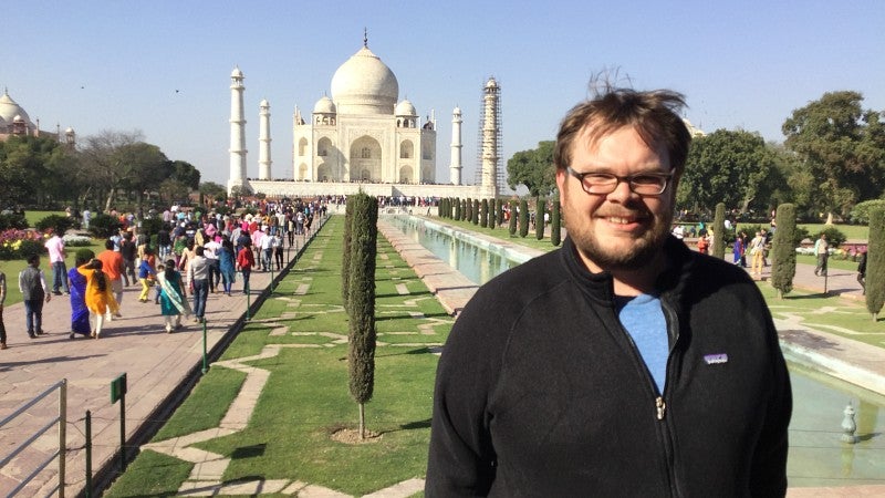 Patric Jones standing by the Taj Mahal