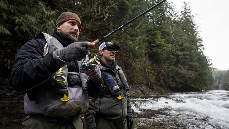 Tim Trainor reels in a fish under the guidance of Drake Radditz on the North Fork Nehalem River.