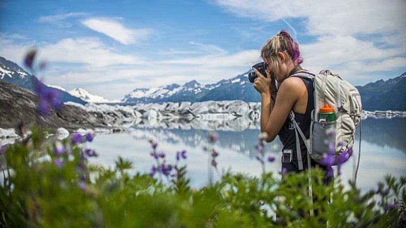 Student taking photographs of flowers. 