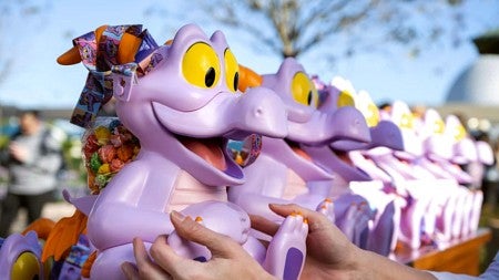 A purple dragon keepsake is grabbed from a row of products.