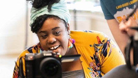 Ranya Salvant operates a video camera while another student looks on