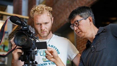 Sung Park instructs a student using a video camera