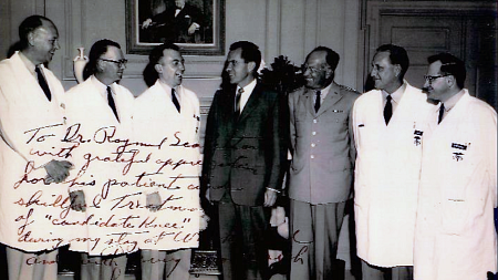 black and white photo of doctors with former President Richard Nixon