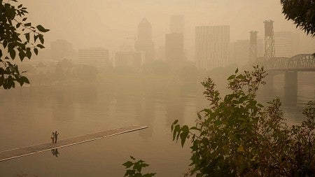 wildfire smoke obscures a view of a bridge in Portland, Oregon