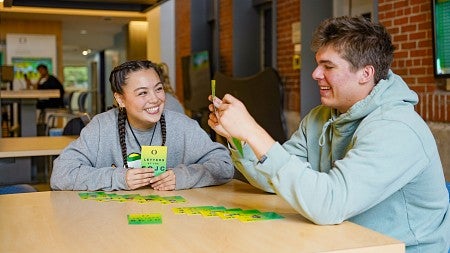 Sydney Seymour and Hunter Pilarski play a card game