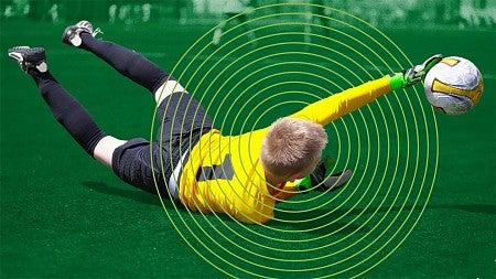 digital composite of a youth soccer goalie diving for a ball with illustrated rings around his head