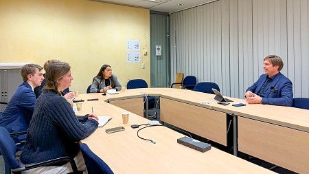 student journalists sit around a U-shaped table