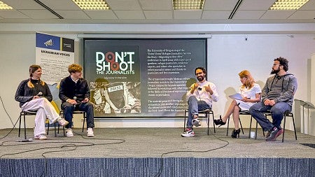 five people sit on a temporary stage