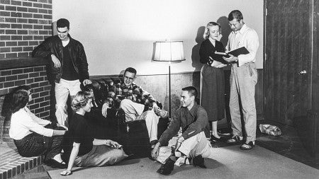 black and white photo from 1954 showing students chatting in the Allen Room