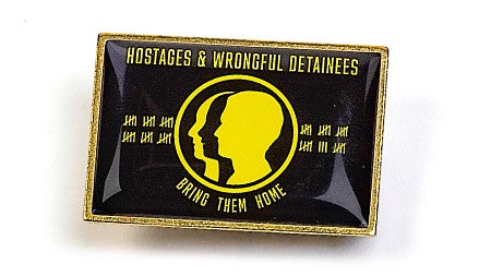 a lapel pin version of the black and yellow Hostage and Wrongful Detainee flag