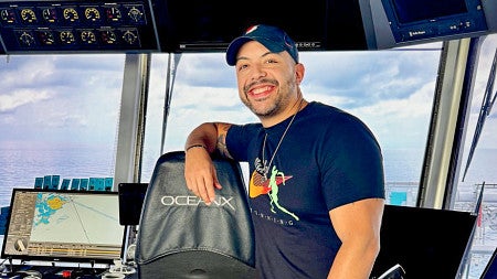 Danny Pimentel poses in the navigation space of the OceanX research ship