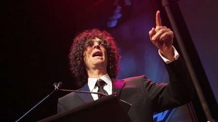 Howard Stern speaking at a podium