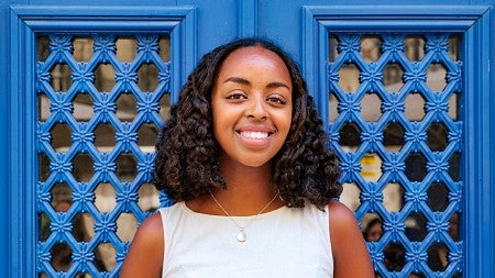 portrait of Hana Mazur in front of vibrant blue doors