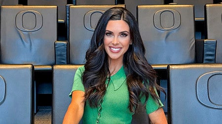 portrait of Bri Amaranthus sitting in a University of Oregon auditorium