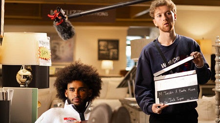 An SOJC student directs football star Dante Moore in a commercial