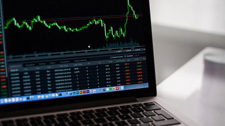 Laptop with stock market on the screen.