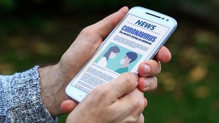 Coronavirus news update on cell phone screen