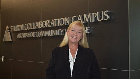 Kristi Strother, wearing a black blazer, smiles at the camera while at the Sturm Collaboration Campus on May 4, 2021 (Photo credit Lucas Miller).