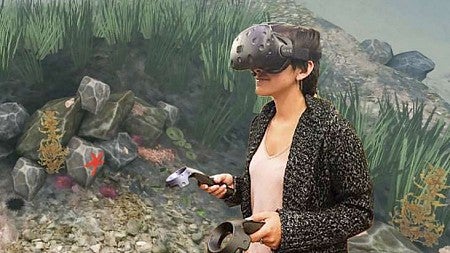 Elise Ogle, a researcher in the Virtual Human Interaction Lab, tries out the Stanford Ocean Acidification Experience