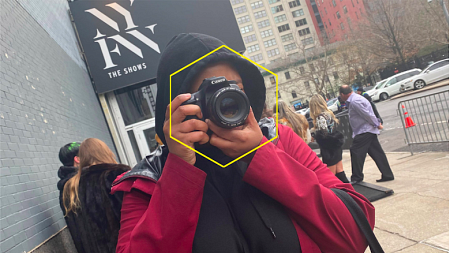 Polly Irungu taking photos during a rainy 2020 New York Fashion Week