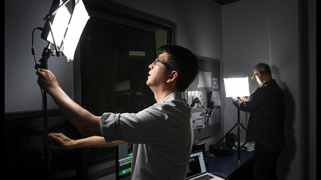 Professor Sung Park (left) and Academic IT Manager Matt Schmidt set up a video production room for remote learning.