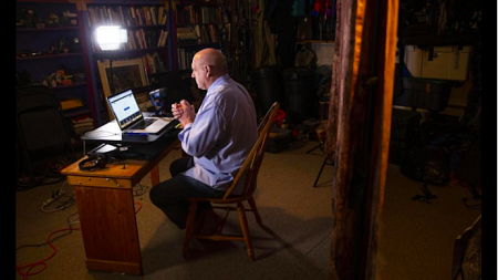 Dan Morrison in his garage records a class to publish online for his students