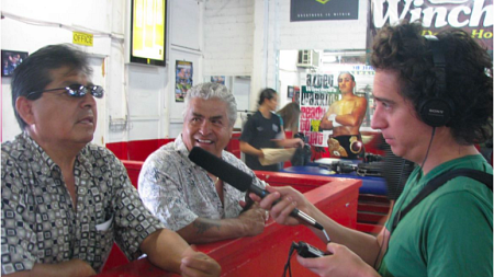 "Radio Ambulante" co-founder Daniel Alarcón records an interview with boxing fans on an early reporting trip.