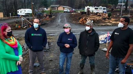 Bethany Howe, Corey Rivera, Melynda Small, Ty Small and Marc Brooks stand together in the rubble of the Echo Mountain Fire.