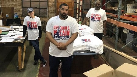 Rags of Honor veterans work on USS John S. McCain T-shirts for the 2019 Fourth of July celebration.