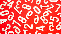 Random white numbers jumbled together on a red background (By Black ice from Pexels).