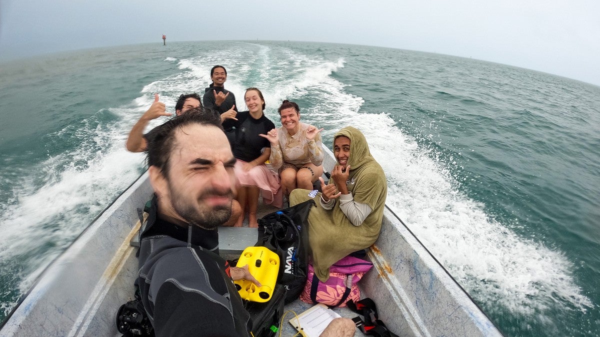 a group of people riding on a boat in the ocean