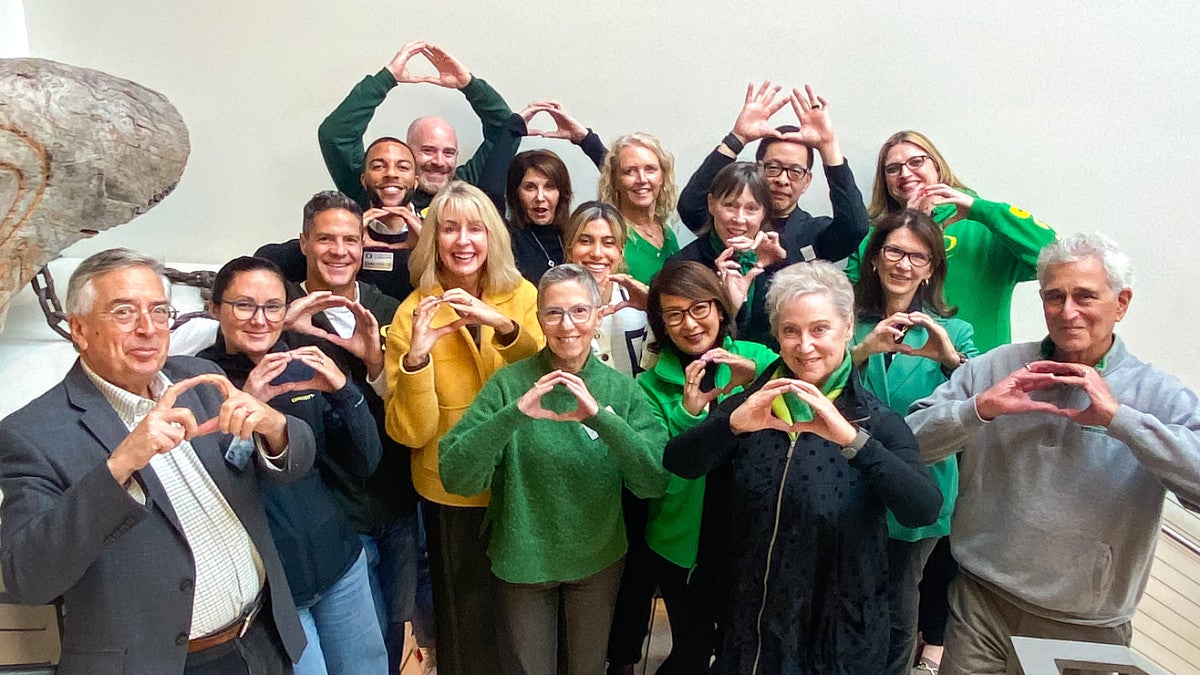 group of people throwing their Os