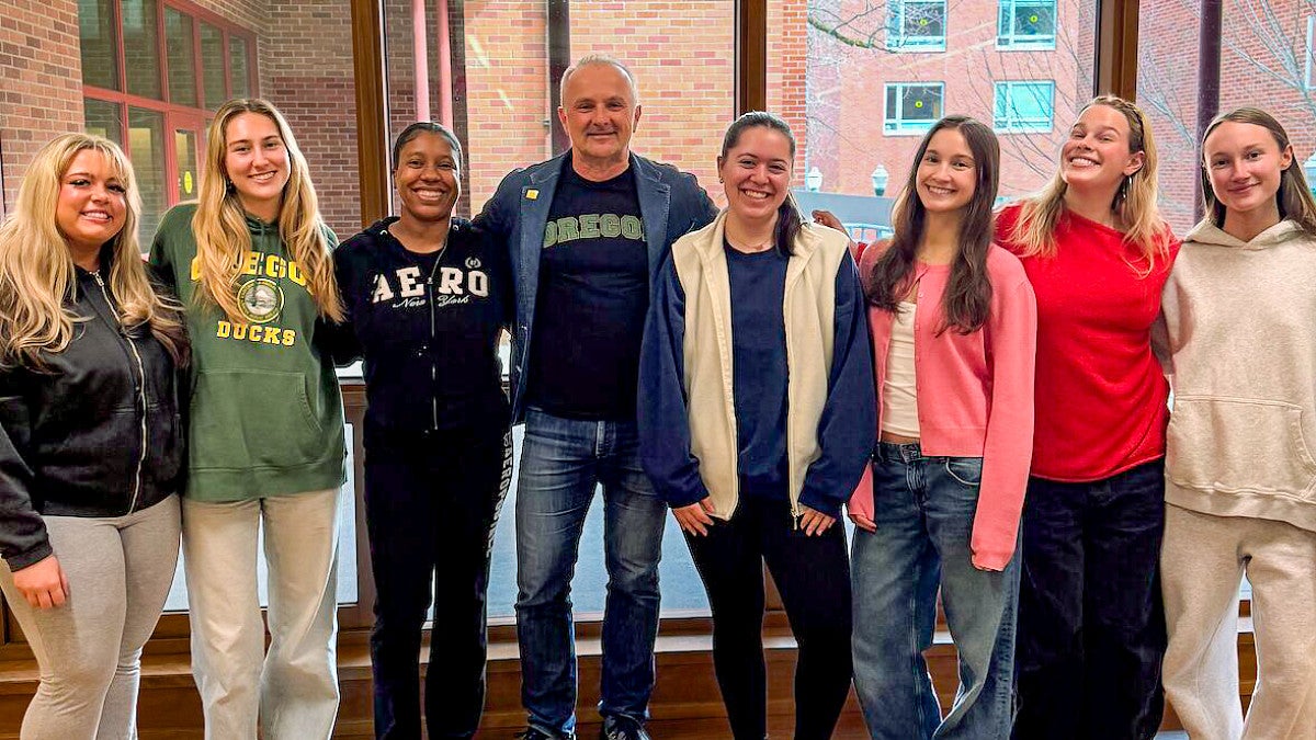 a group of people pose in front of a window