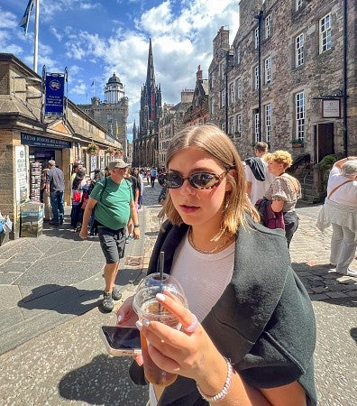 Nicole Alstrin holds an iced coffee in Edinburgh