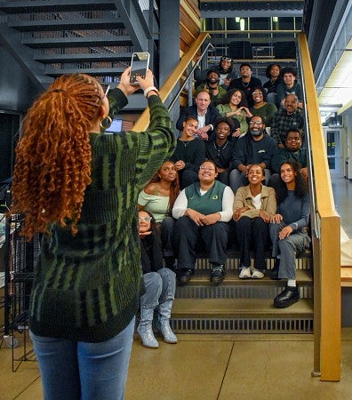 Lia Addisu takes a photo of a group of people sitting on stairs