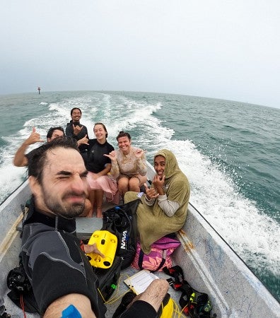 a group of people riding on a boat in the ocean