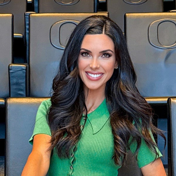 portrait of Bri Amaranthus sitting in a University of Oregon auditorium