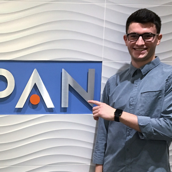 Cameron Rogers standing in front of PAN Communications sign. Cameron Rogers standing in front of PAN Communications sign.