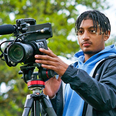 a student films with a video camera