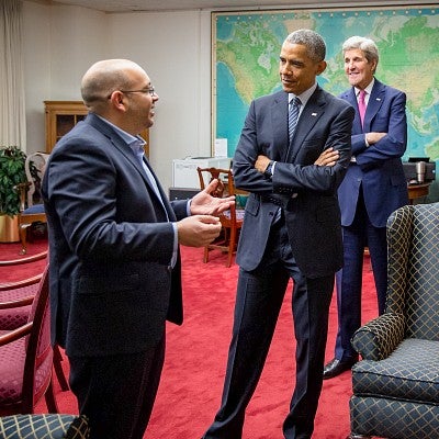 Jason Rezaian stands talking to Barack Obama while John Kerry and others look on