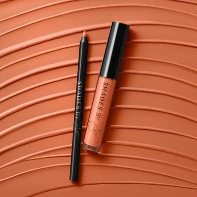 product shot of coral lip kit by Shades by Shan on a textured coral background