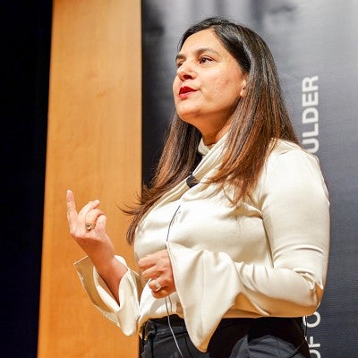 Saima Kazmi speaks at an event