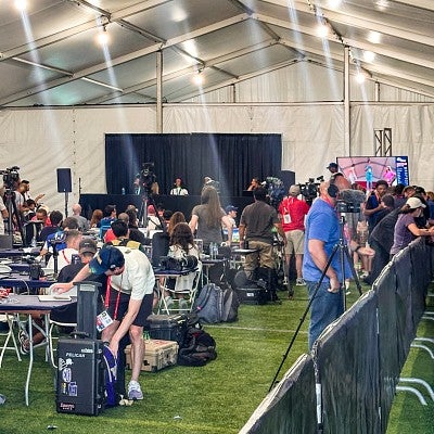 media set up for a press conference in a large tent