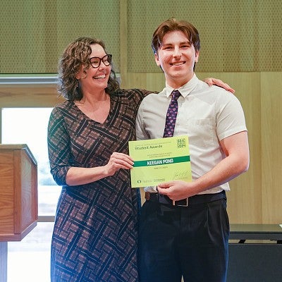 Gretchen Soderlund presents an award to Keegan Pond