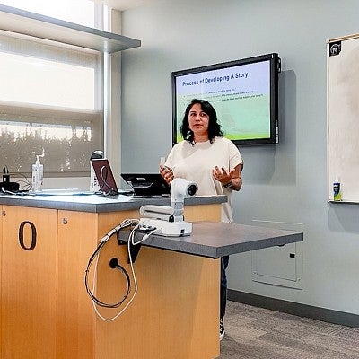 Jackie Gutierrez gives a presentation in a classroom