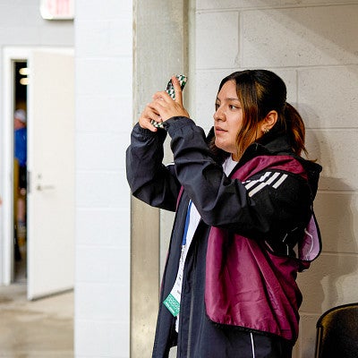 Vanesa Montalvo holds up her phone to record content