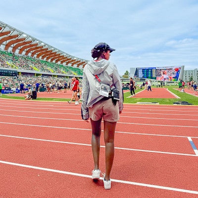Hana Mazur faces away from the camera looking out over Hayward Field
