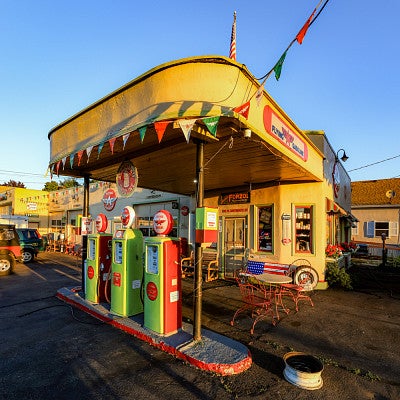 a retro gas station with colorful pumps